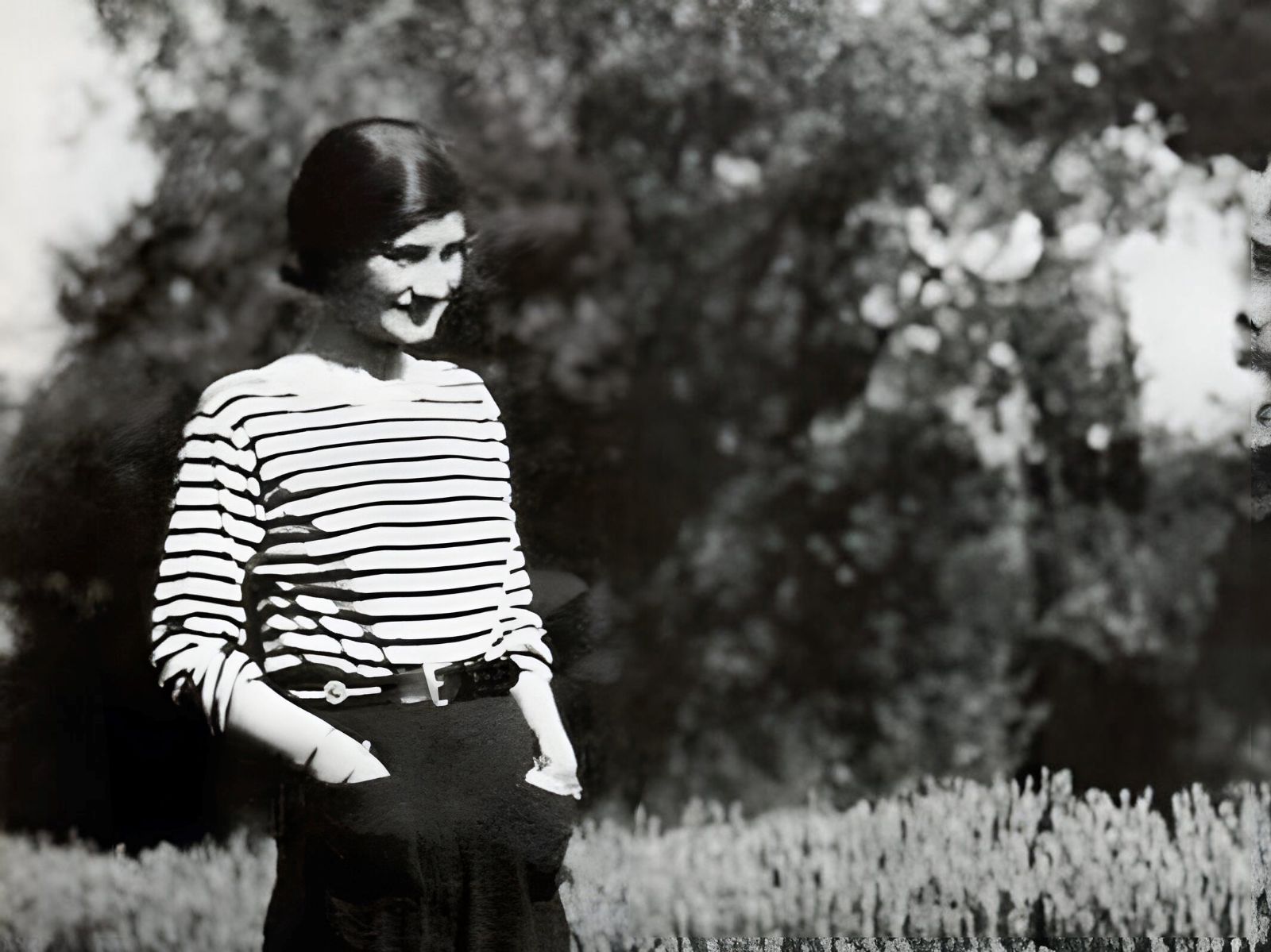 Black and white image of Coco Chanel wearing striped jersey