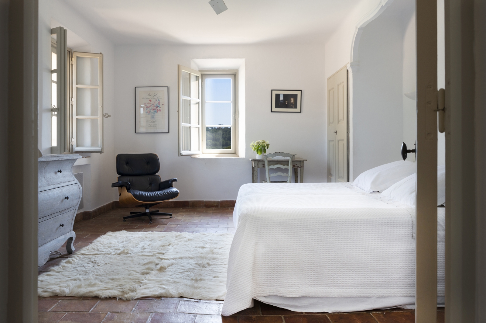Bedroom with double bed, desk, table, armchair, drawers and picture frames at La Cadiere on the Cote d’Azur, France
