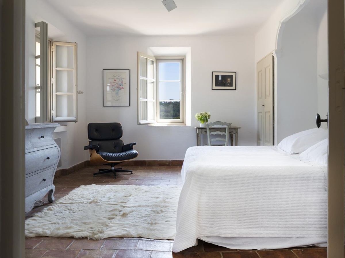 Bedroom with double bed, desk, table, armchair, drawers and picture frames at La Cadiere on the Cote d’Azur, France