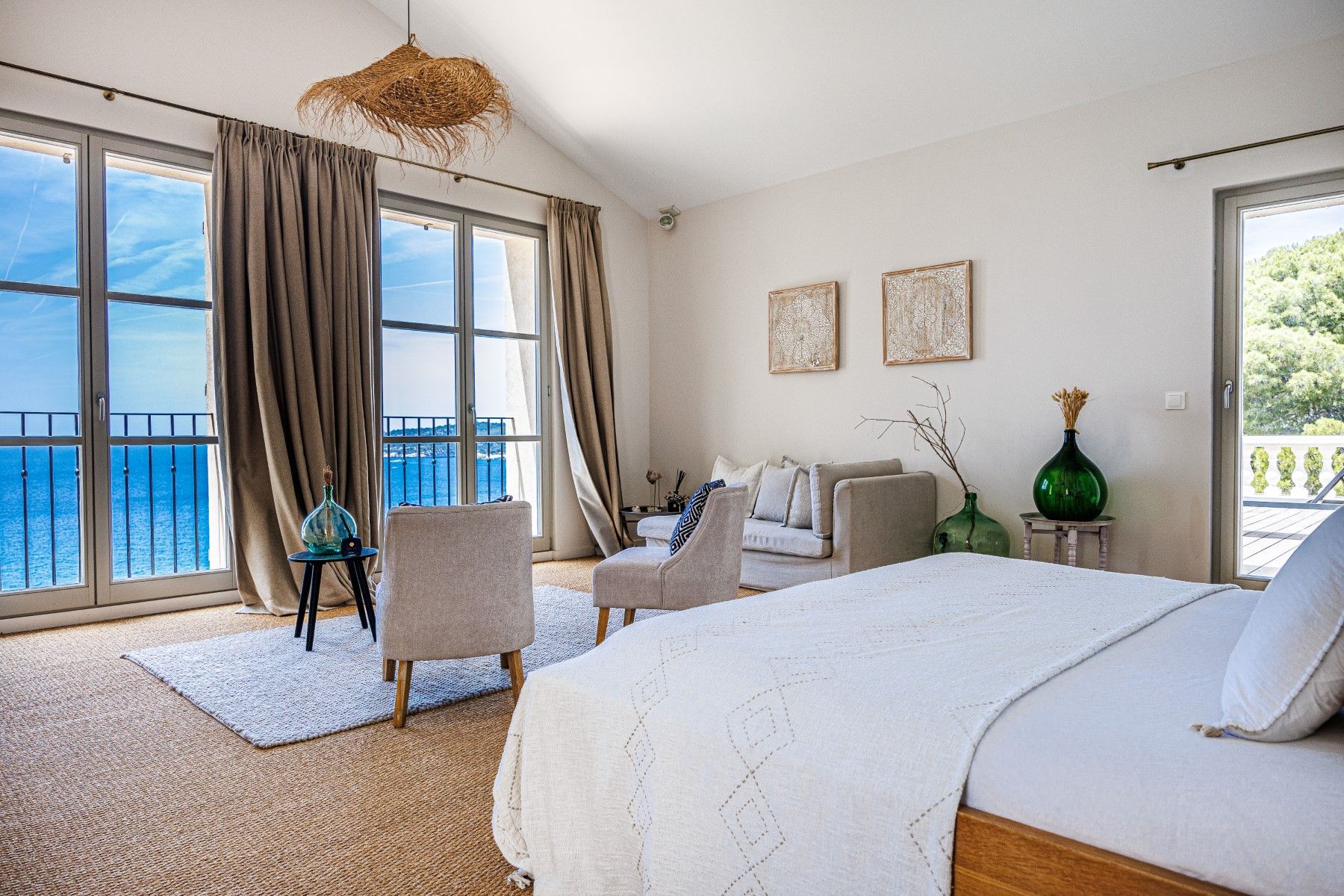 Double bedroom with two chairs, sofa and sea view at Villa Florie in Côte d'Azur