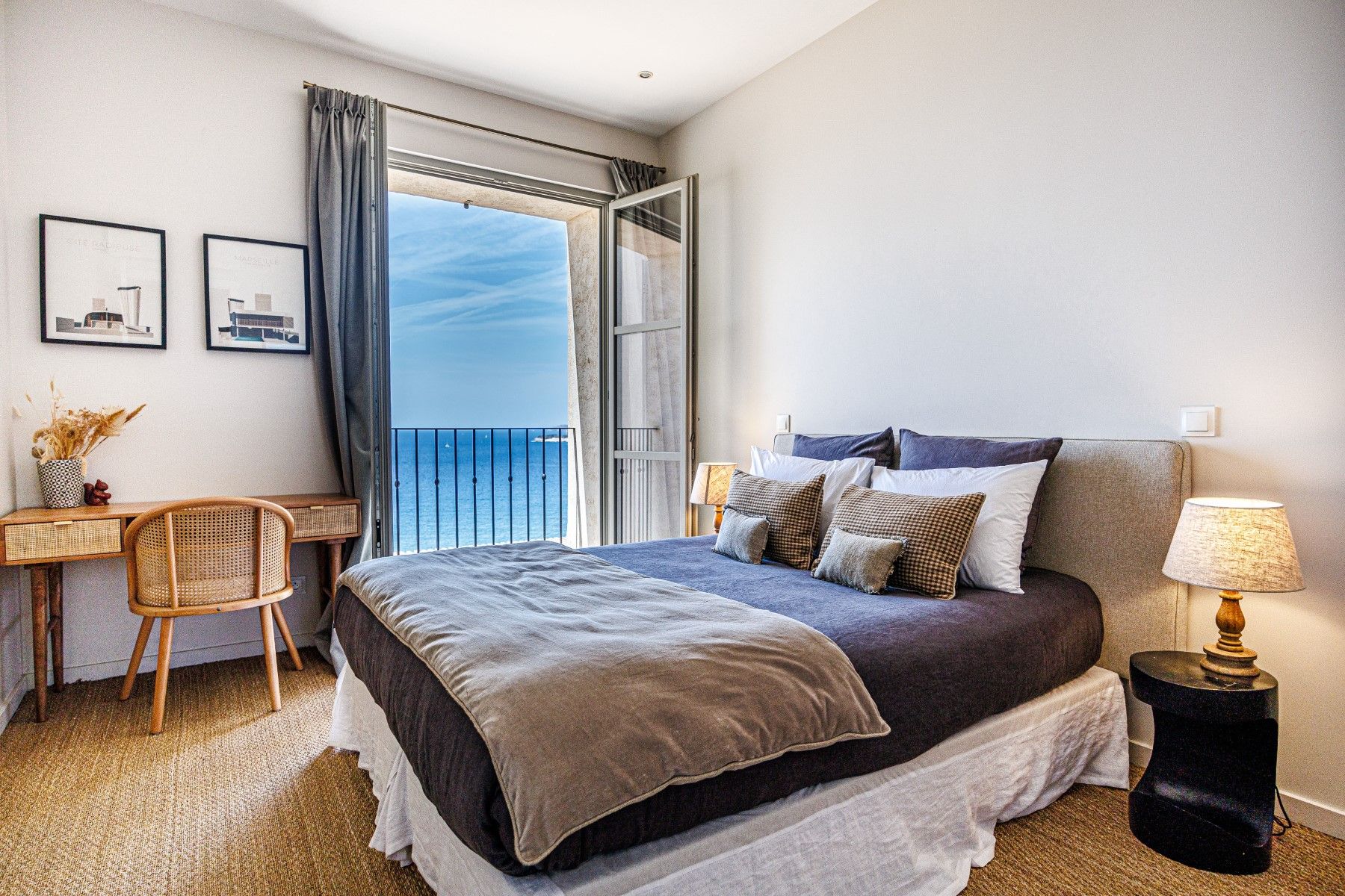 Grey double bedroom with vanity and sea view balcony at Villa Florie in Côte d'Azur