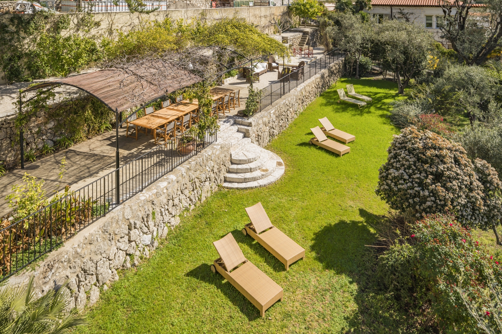 Loungers dotting the lawns in front of the terrace at luxury Villa Malvan, in the Cote d'Azur
