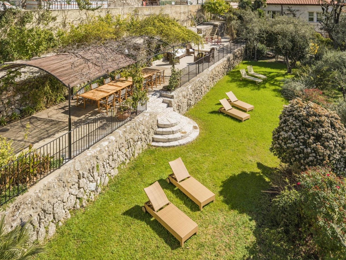 Loungers dotting the lawns in front of the terrace at luxury Villa Malvan, in the Cote d'Azur