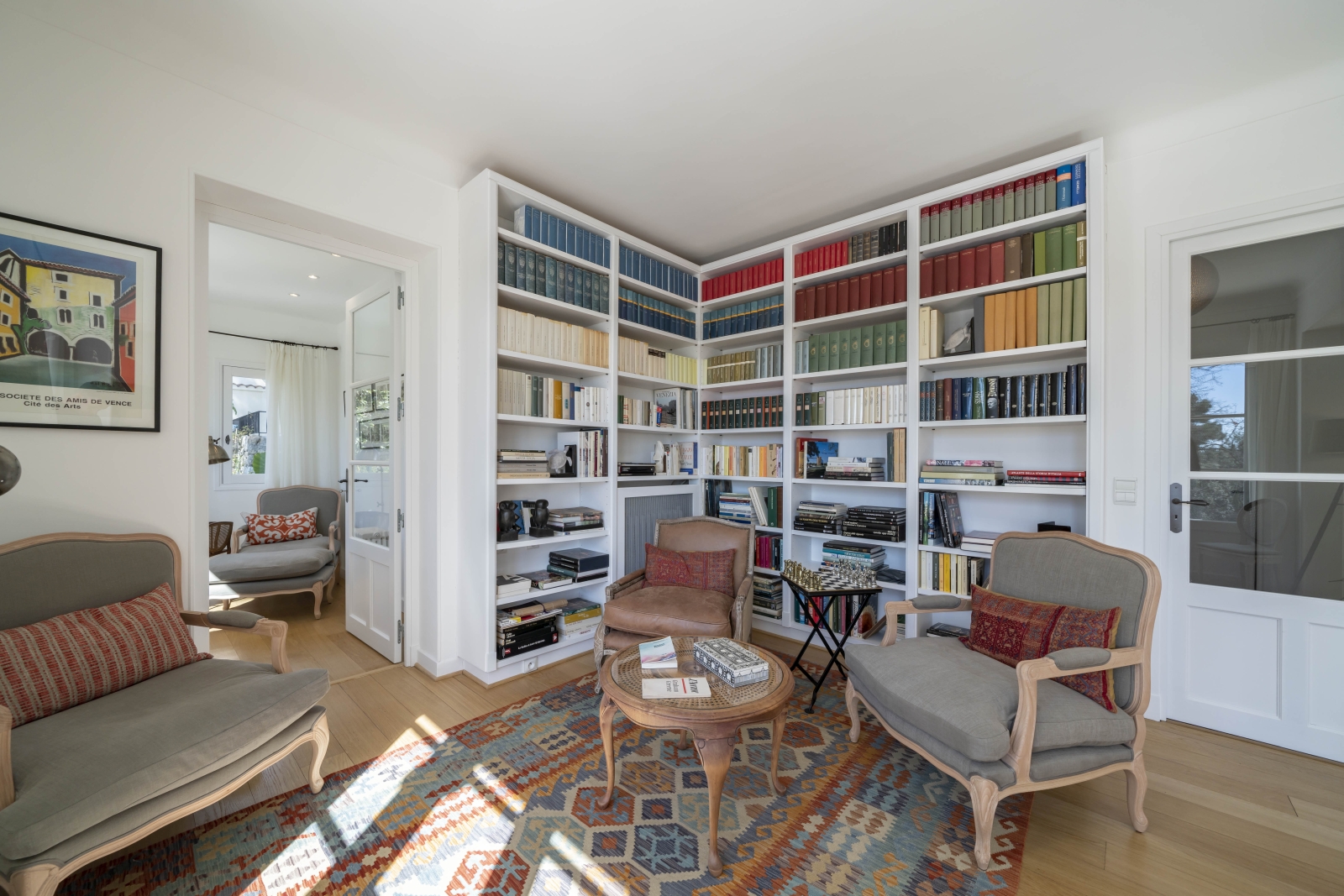well-stocked library corner with two comforable chairs at Villa Malvan, luxury villa in France