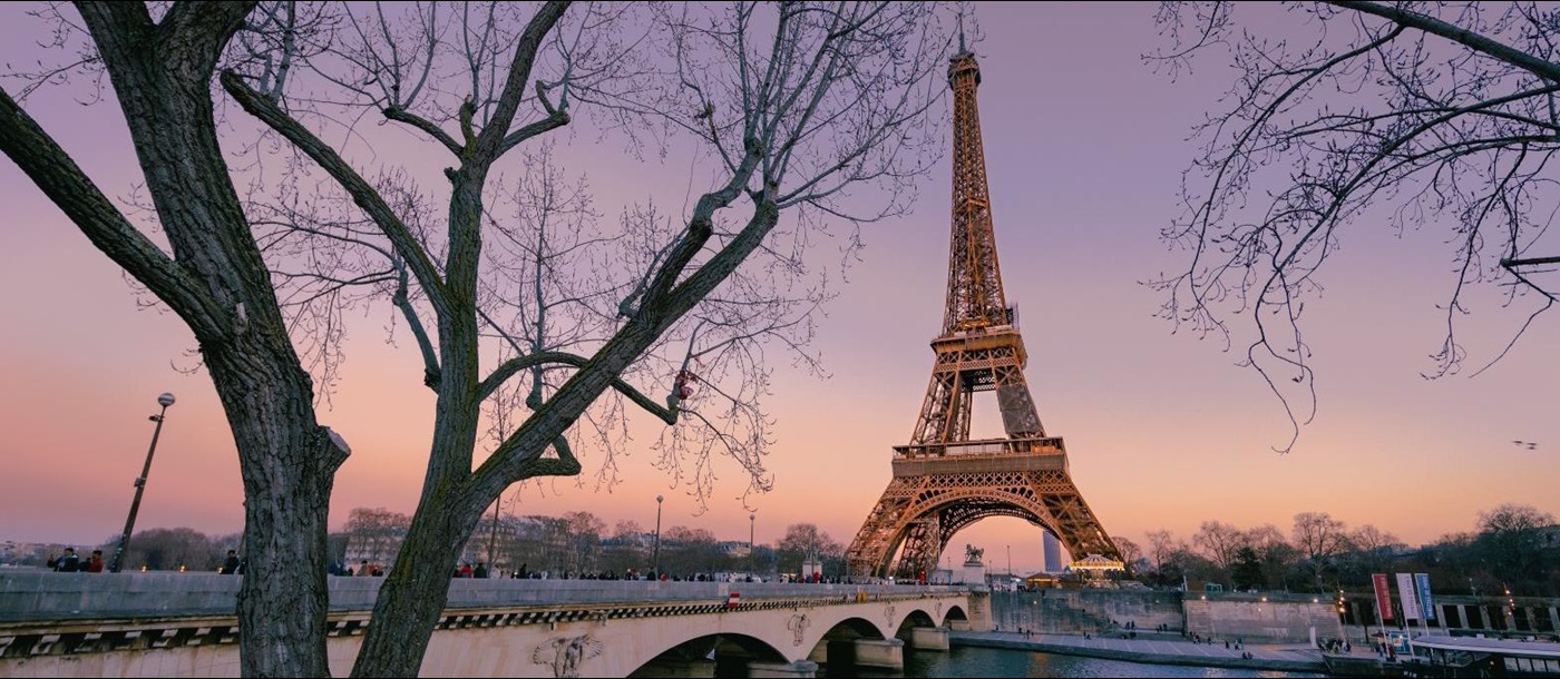 View of the Eiffel Tower across the Seine at dusk