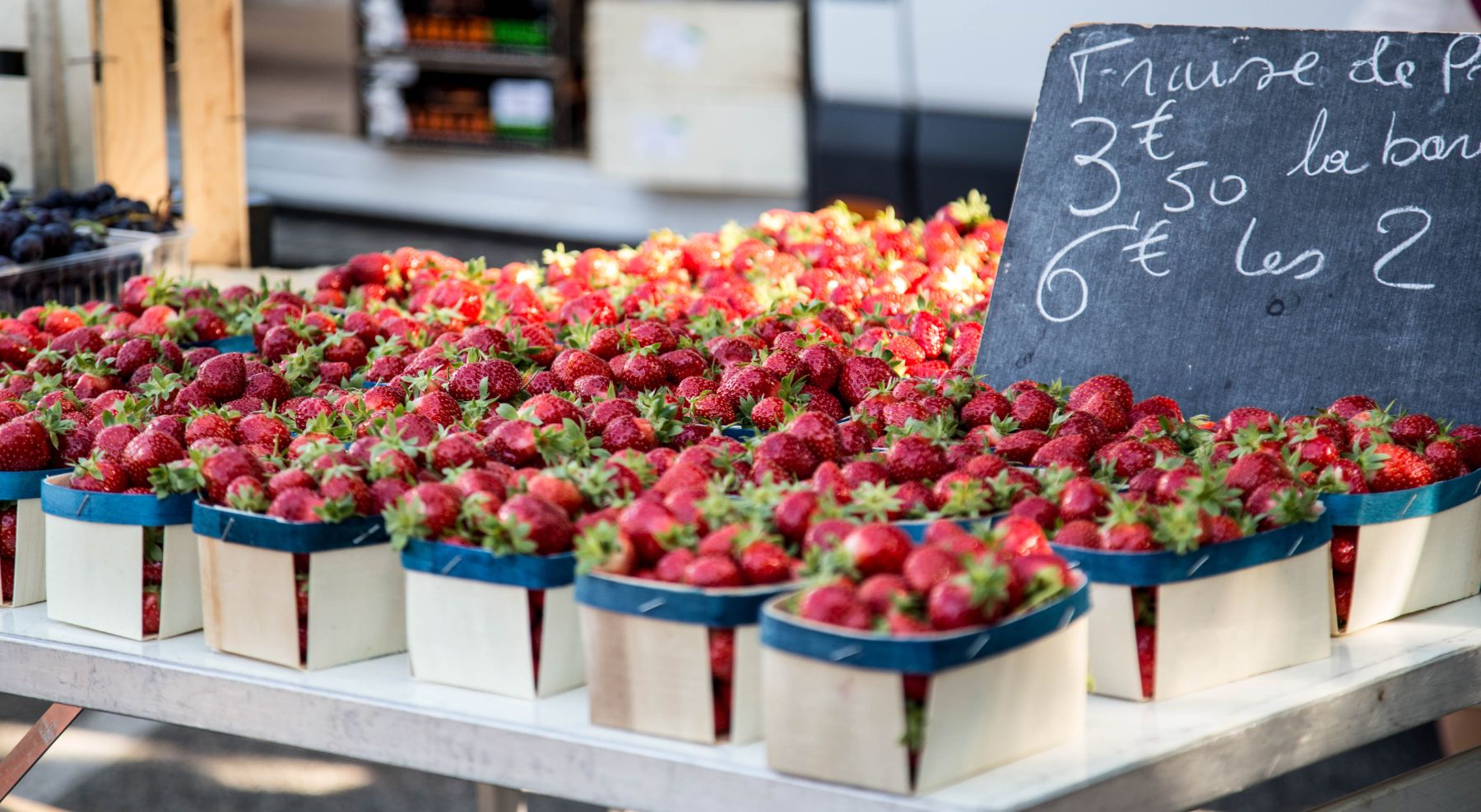 Punnets of strawberries on display at a market stall in France