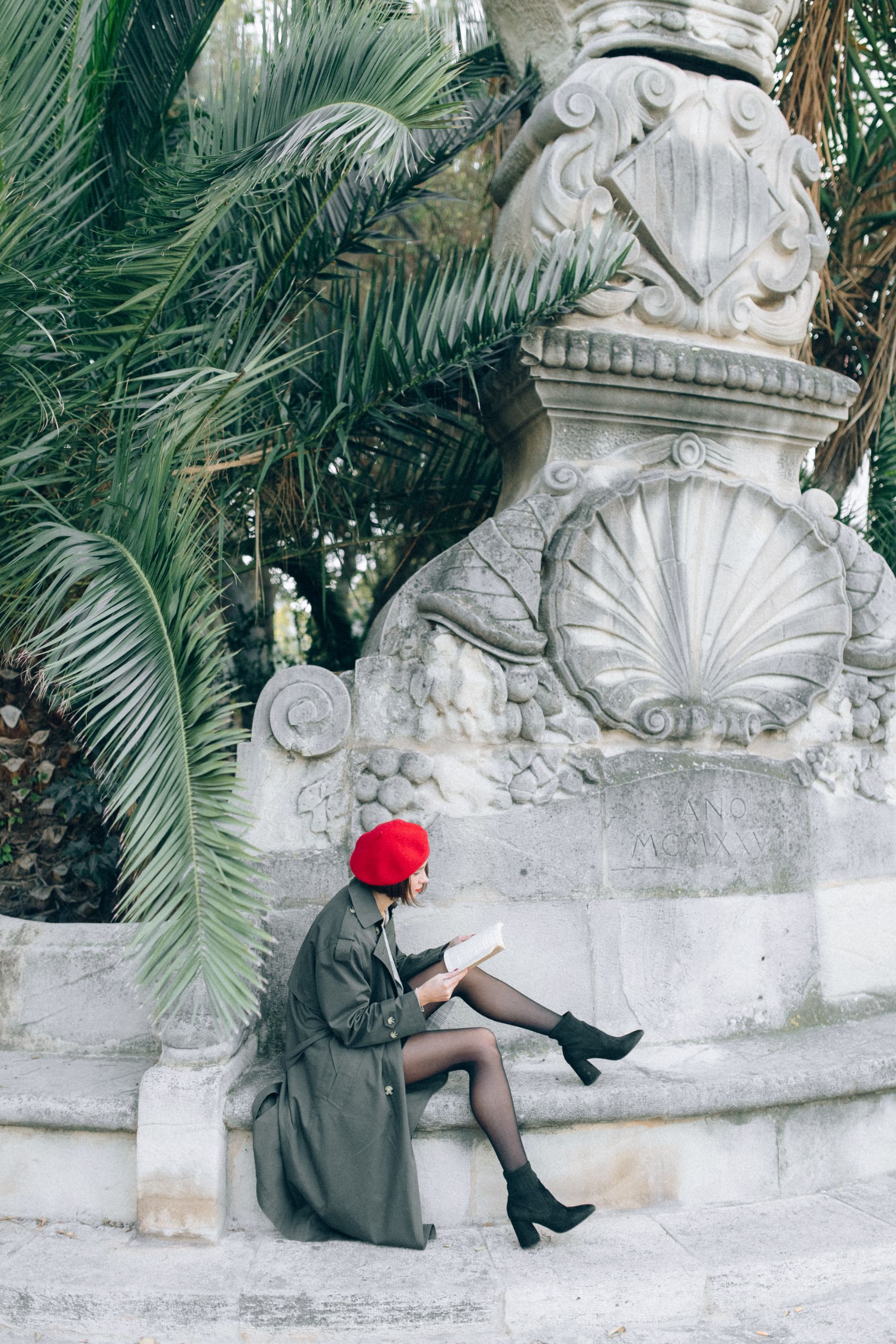 A model wearing a red French beret in Paris