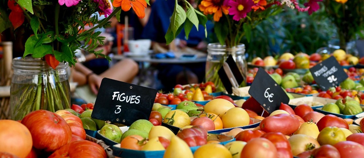 Colourful fruit, vegetable and flowers on display at a French market