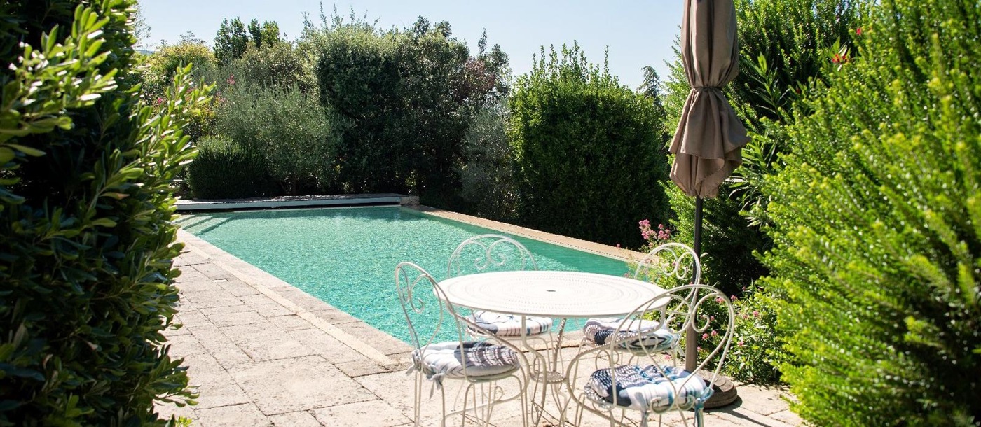 Table and chairs by the pool at Bastide d'Aristide in Provence