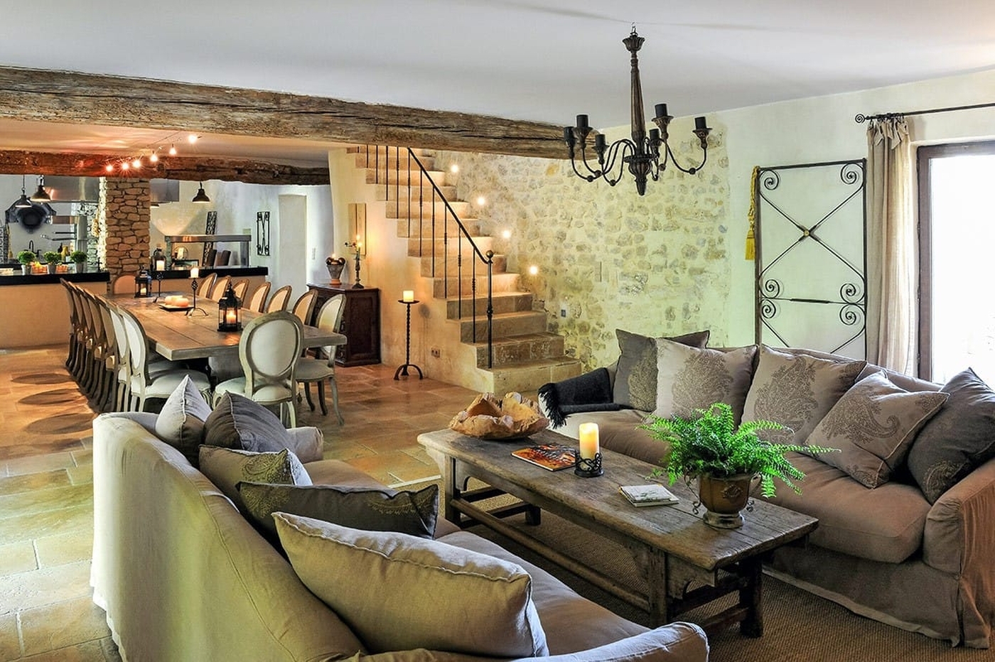 Lounge area with sofas with dining table in background at Bastide Sur La Sorgue in Provence