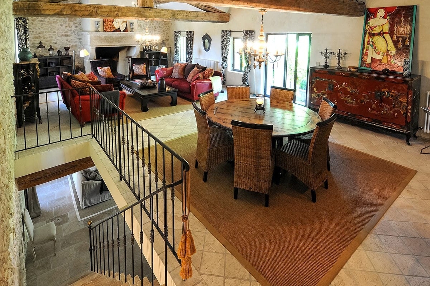 Round dining table and comfortable sofas at Bastide Sur La Sorgue in Provence