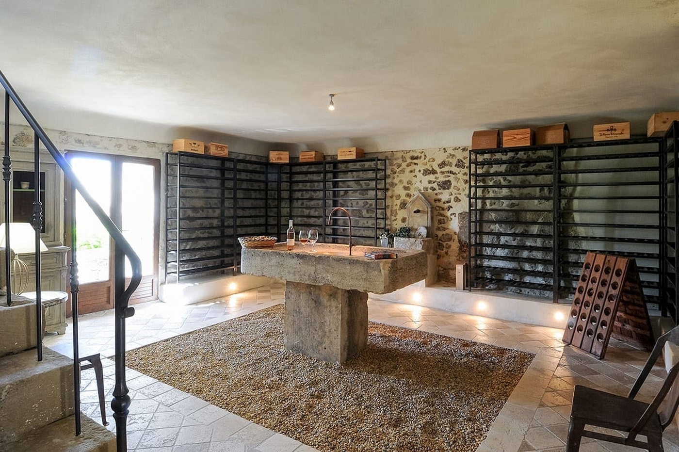 Stone wine cellar with tasting table at Bastide Sur La Sorgue in Provence