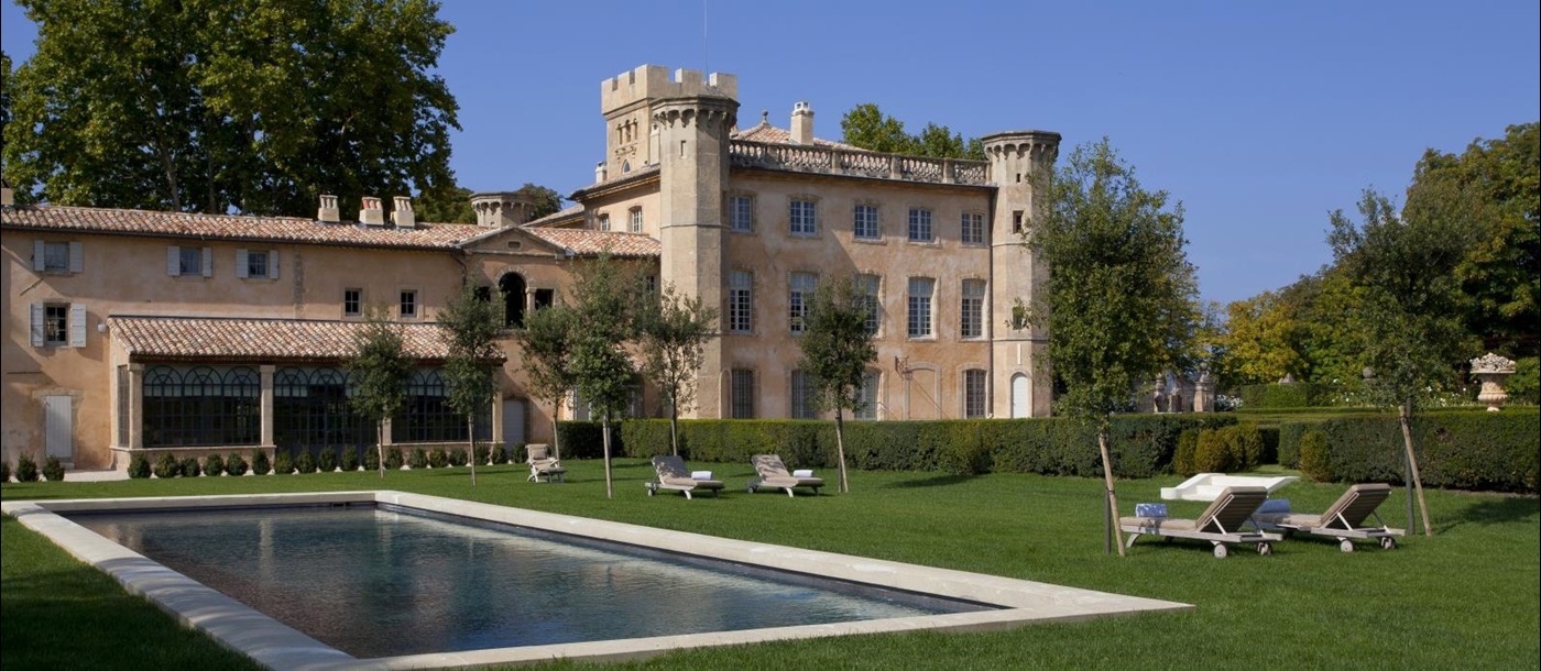 Pool and lawn in the gardens at Chateau Bel Esprit in Provence, France