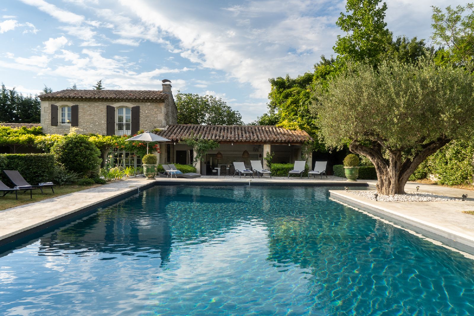Pool with villa in the background at La Colombe in Provence