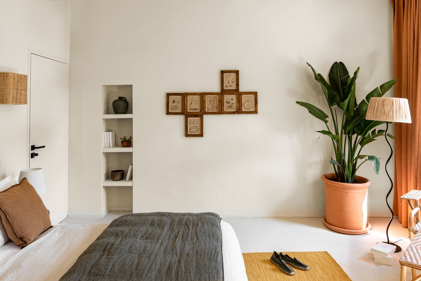 bedroom with green plant and standing lamp