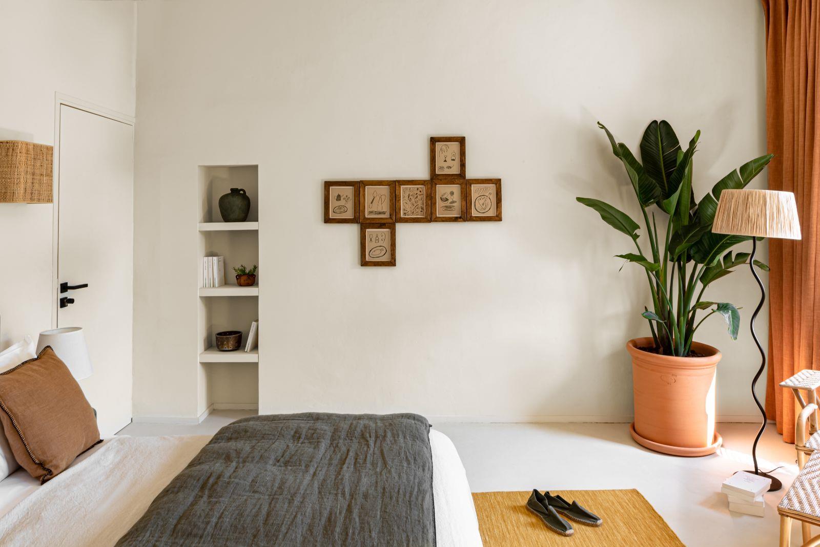 bedroom with green plant and standing lamp