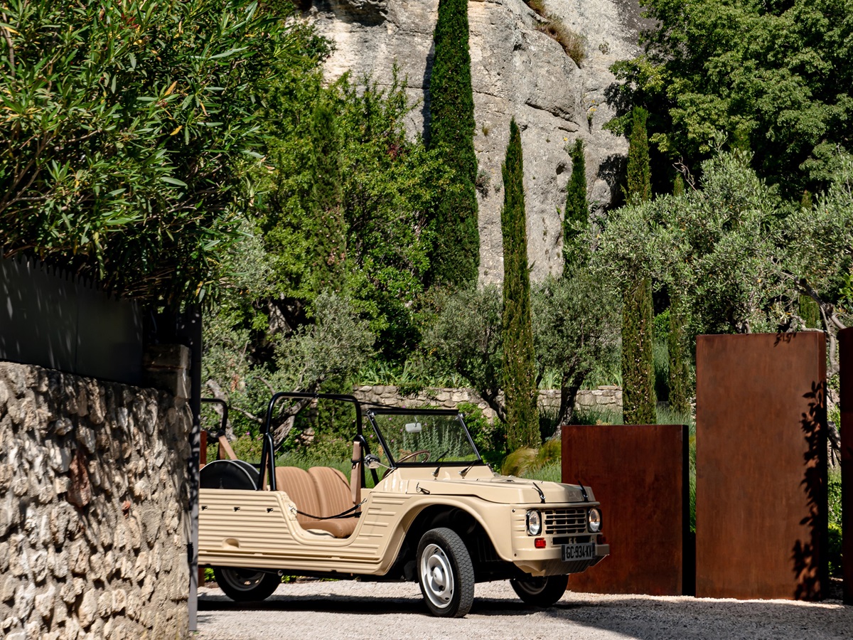 mini moke infront of rock garden