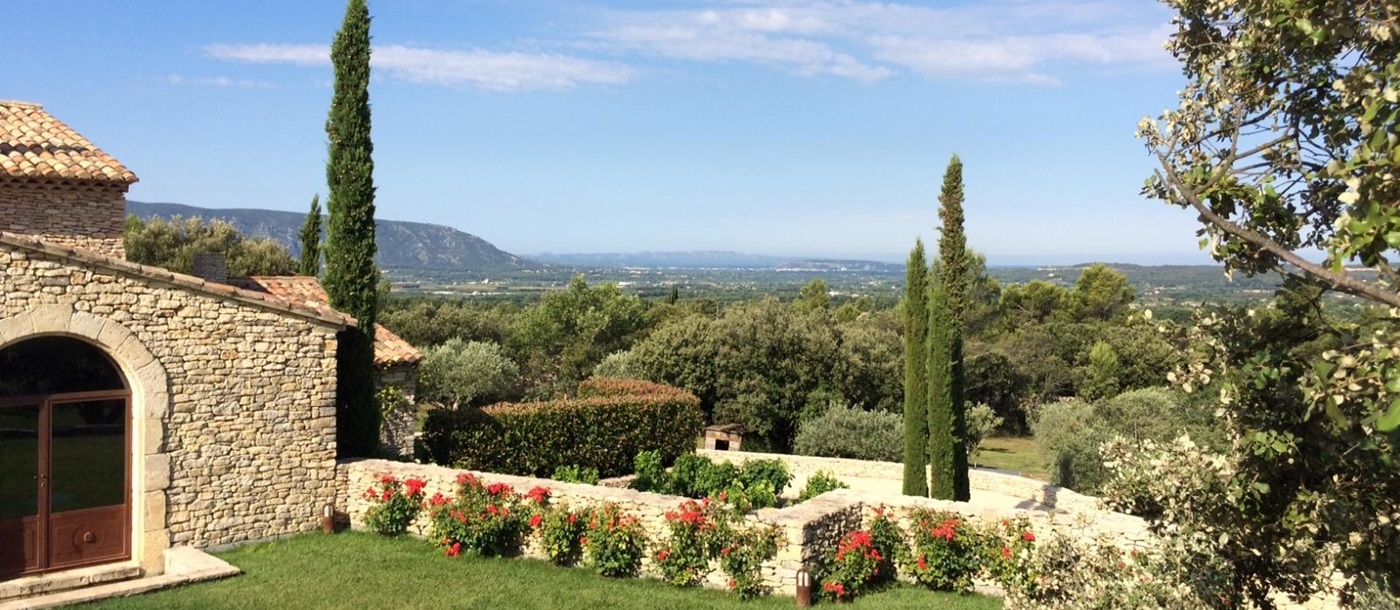 Garden with flowers, trees and countryside view at Le Clos in Provence, France