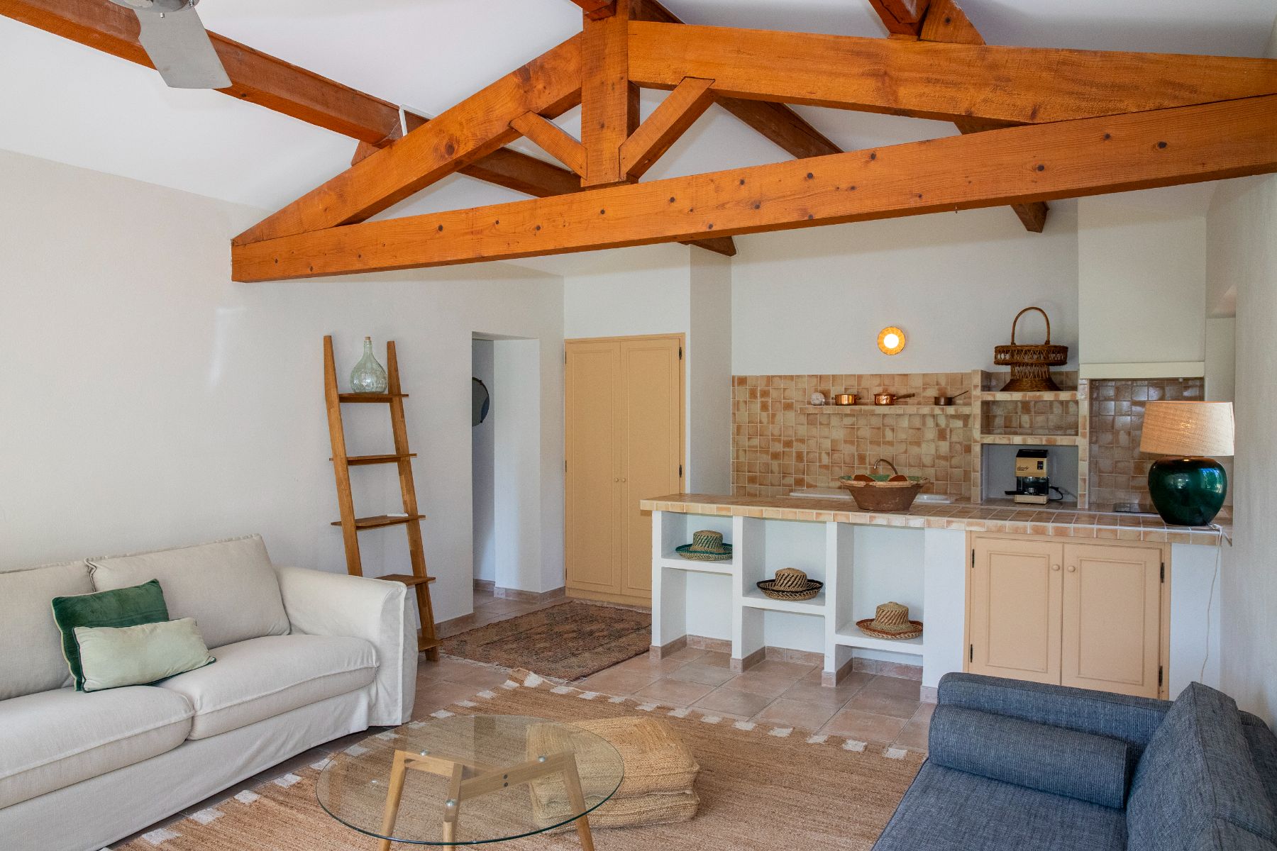 Living area with white and blue sofas at Maison Les Baux in Provence, France