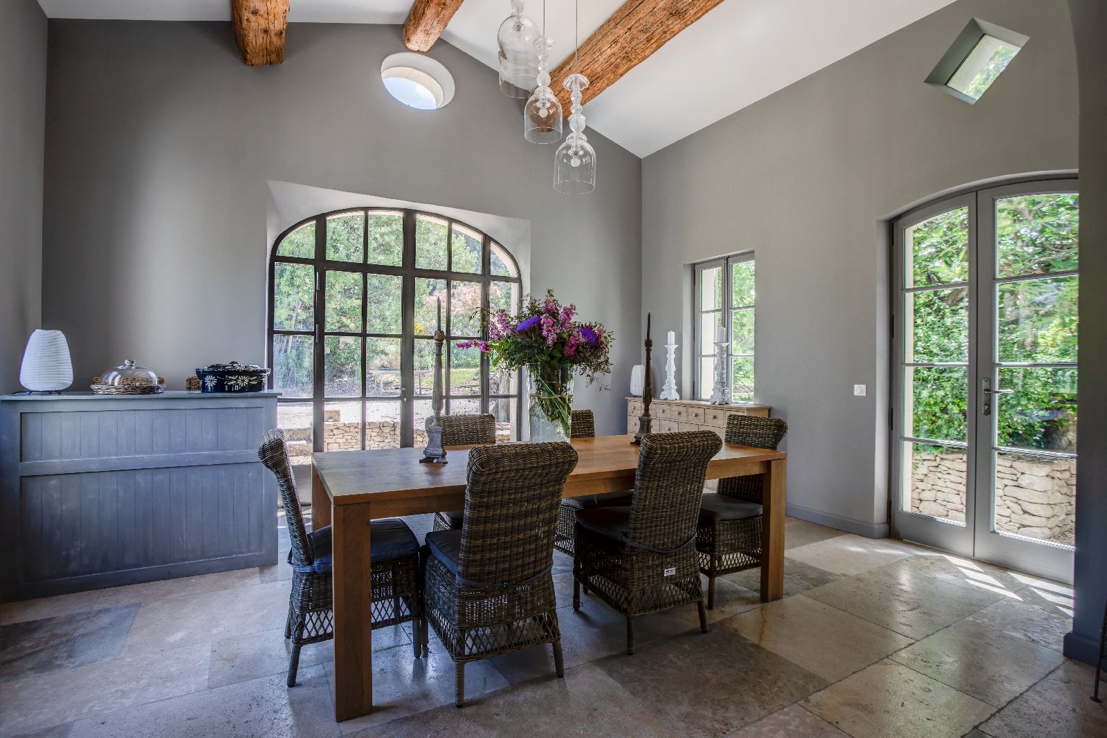 Dining room with large windows at Mas Calanquet in Provence