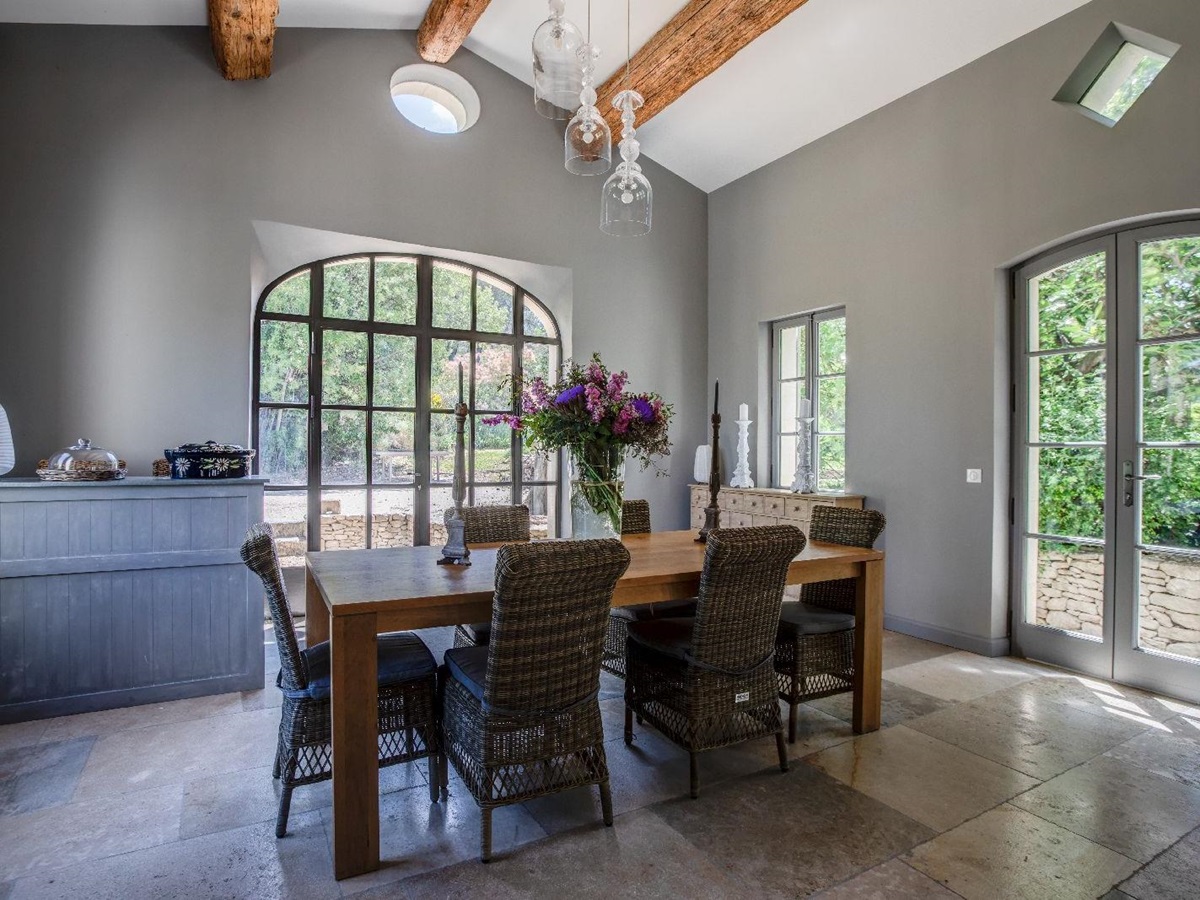 Dining room with large windows at Mas Calanquet in Provence