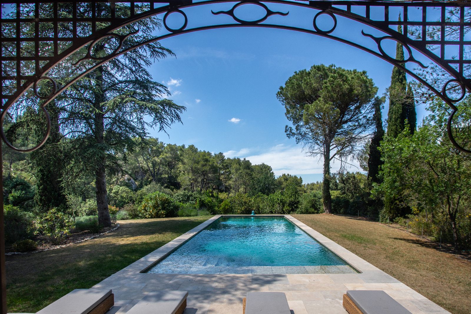 Metal arch leading to pool at Mas Calanquet in Provence