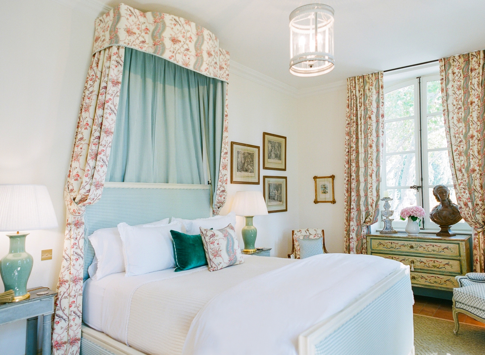 Bedroom with double bed, bedside tables, lamps, armchairs & pictures at Mas de la Motte in Provence, France