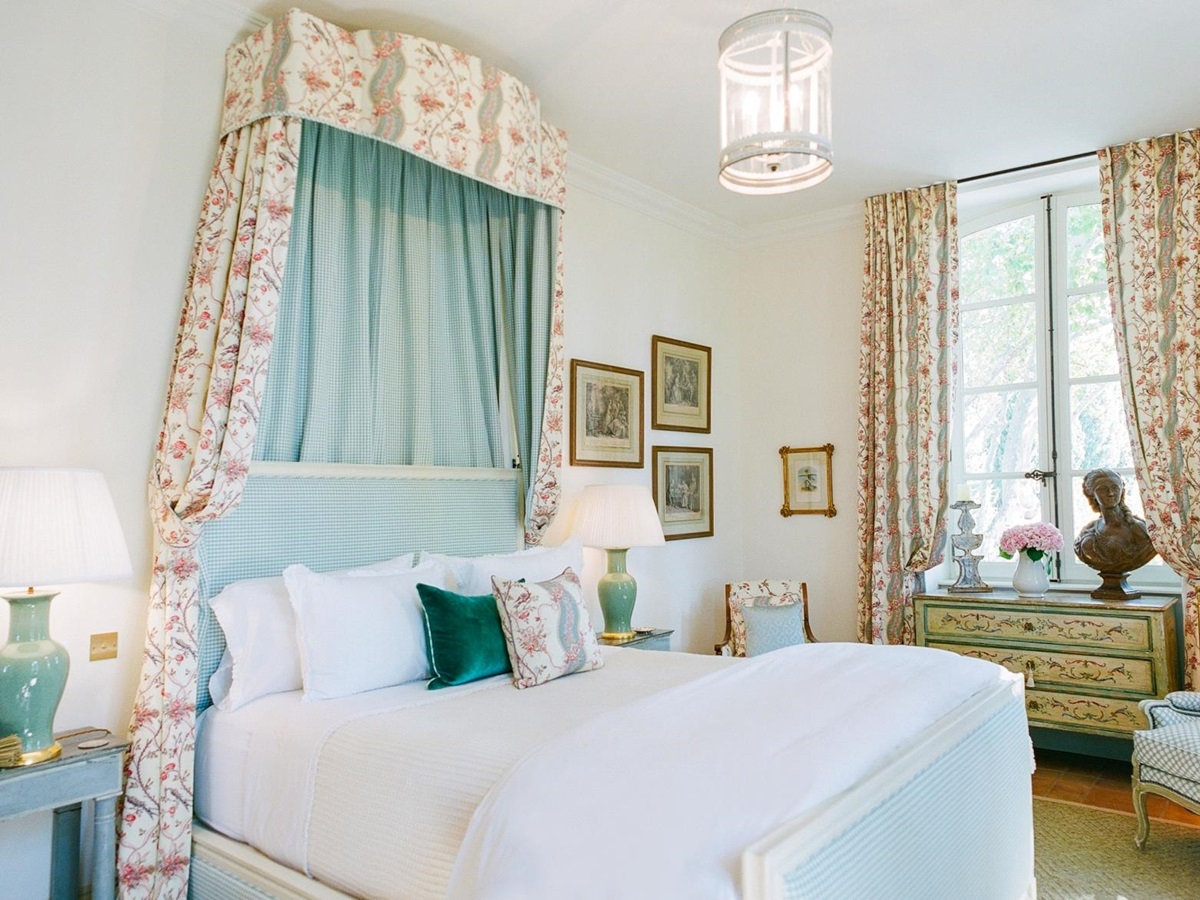Bedroom with double bed, bedside tables, lamps, armchairs & pictures at Mas de la Motte in Provence, France