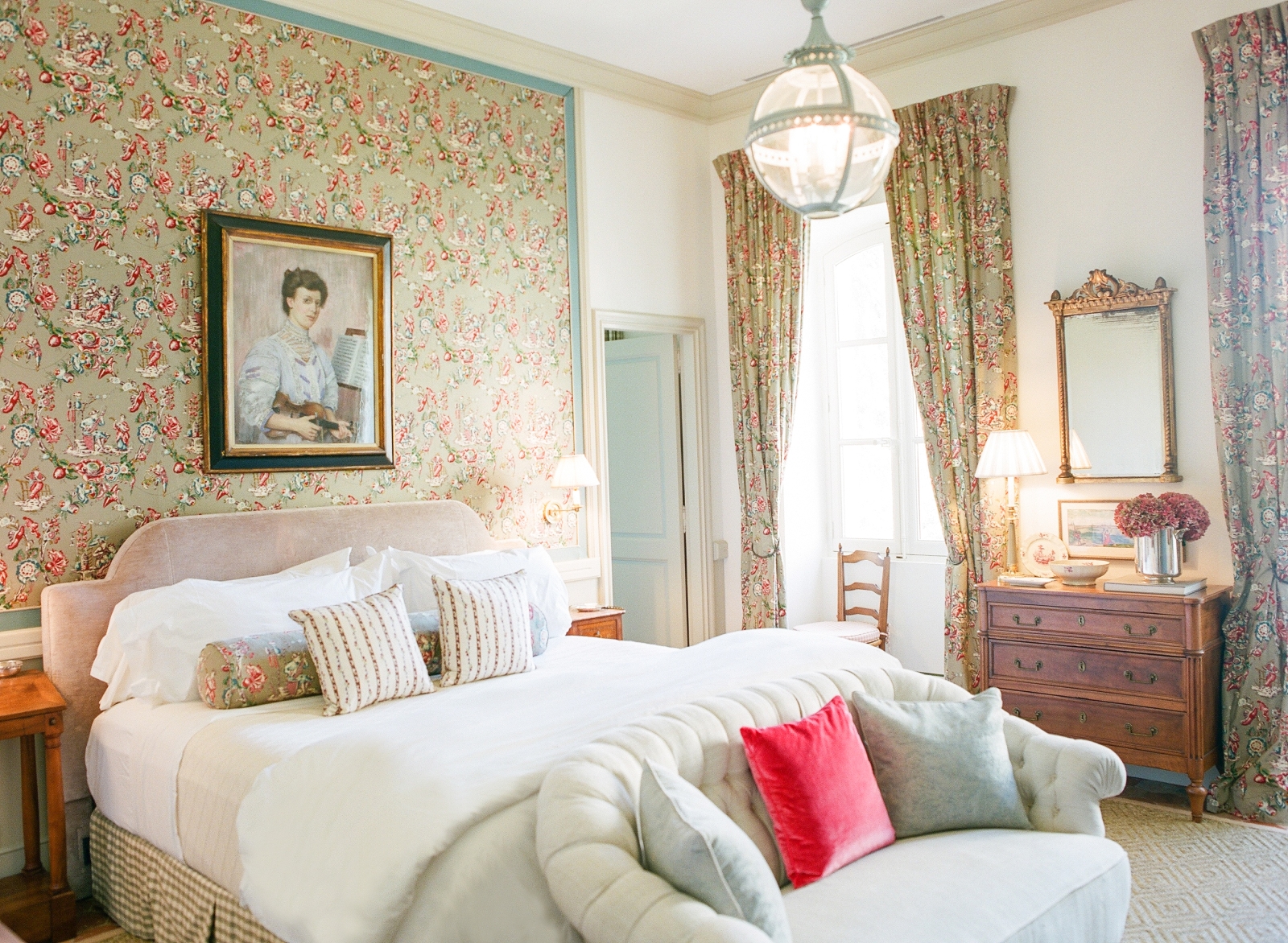 Bedroom with double bed, sofa, artwork, drawers and Pierre Frey fabric at Mas de la Motte in Provence, France