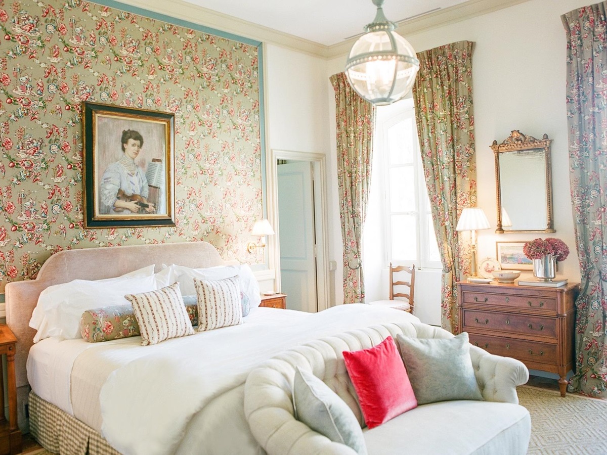 Bedroom with double bed, sofa, artwork, drawers and Pierre Frey fabric at Mas de la Motte in Provence, France