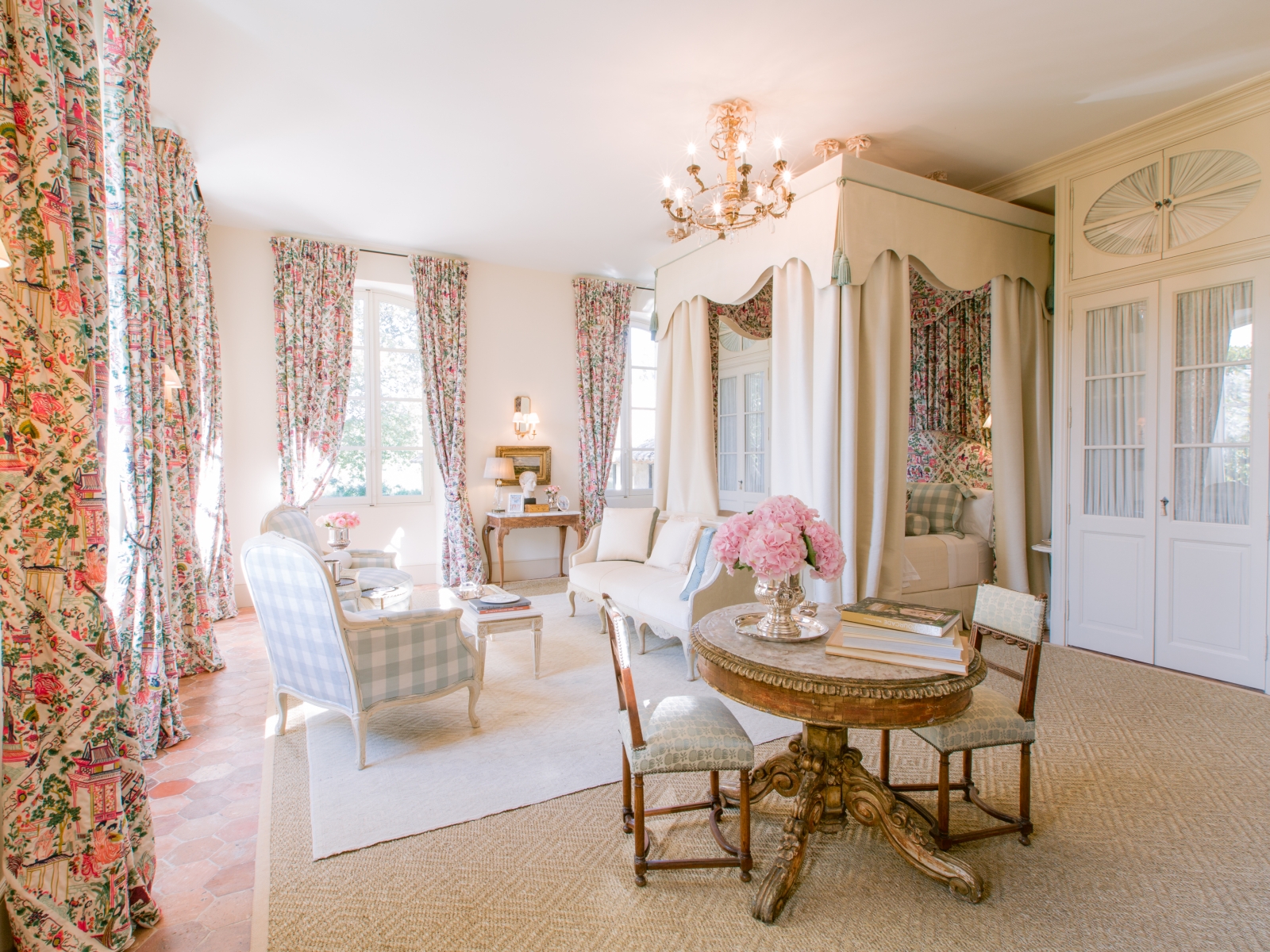 Master bedroom with canopy bed, sofa, armchairs, table, chairs & Pierre Frey fabric at Mas de la Motte in Provence, France