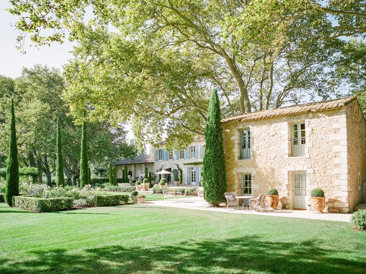 View of guest house, villa and garden with trees and hedges at Mas de la Motte in Provence, France