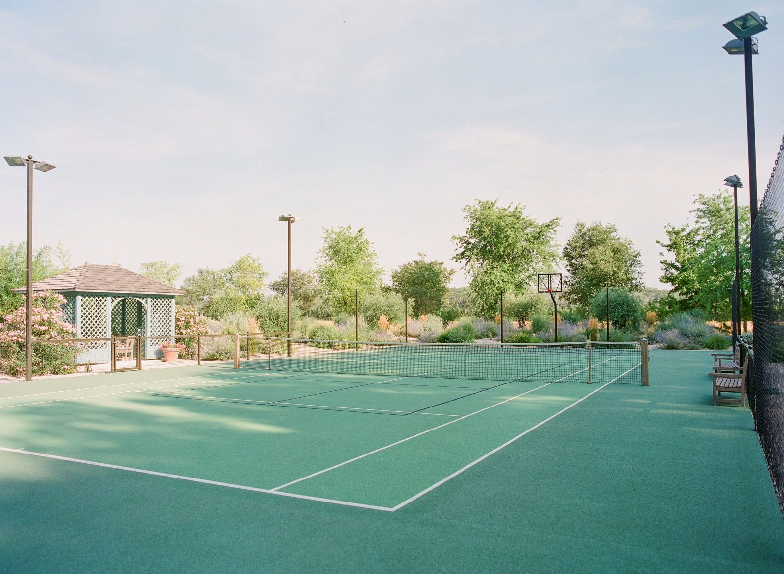 Tennis court with hut and flood lights at Mas de la Motte in Provence, France