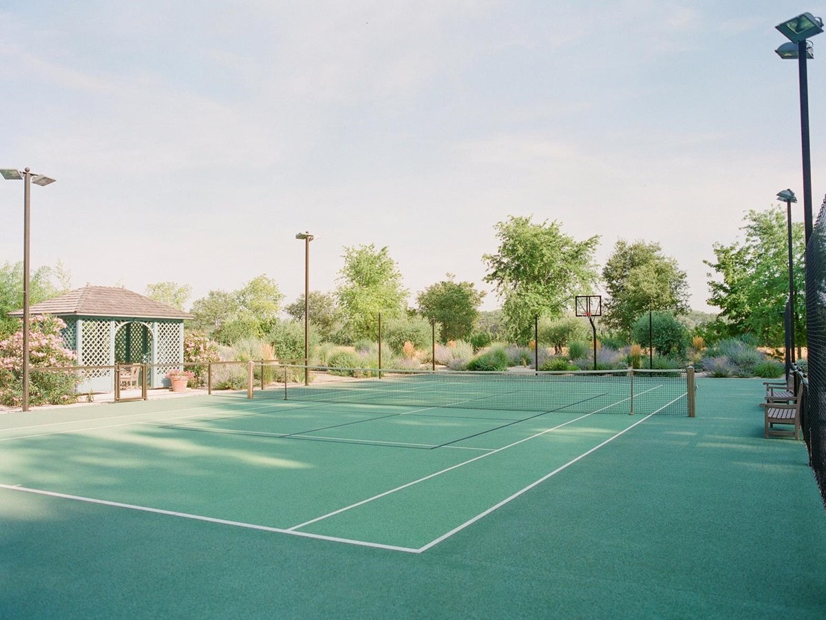 Tennis court with hut and flood lights at Mas de la Motte in Provence, France