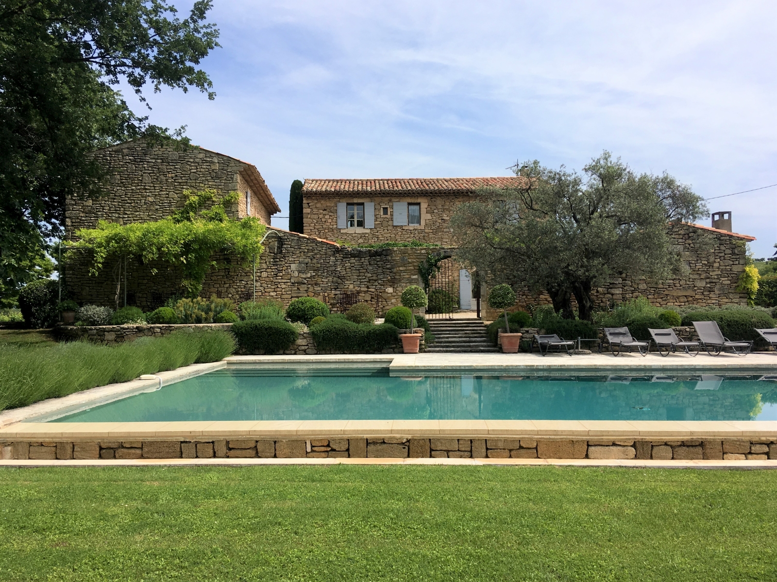 Swimming pool and pool area with sun loungers at Mas des Cerisiers in Provence, France