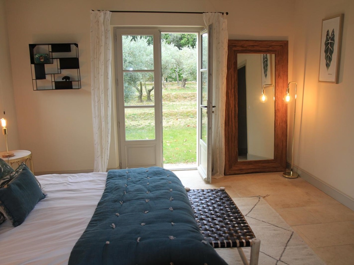 Double bedroom with large french doors leading to garden at Mas Eygalieres in Provence