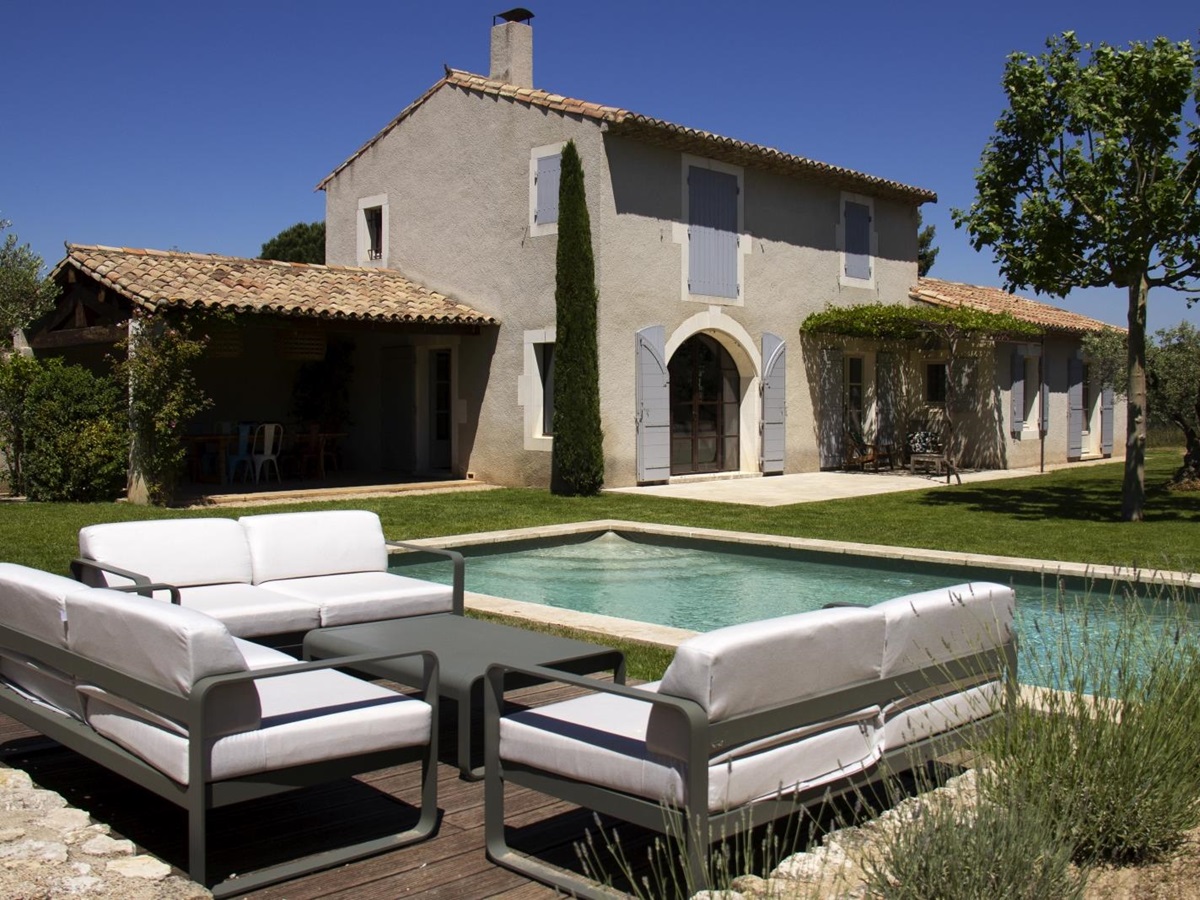 Poolside seating with villa in background at Mas Eygalieres in Provence