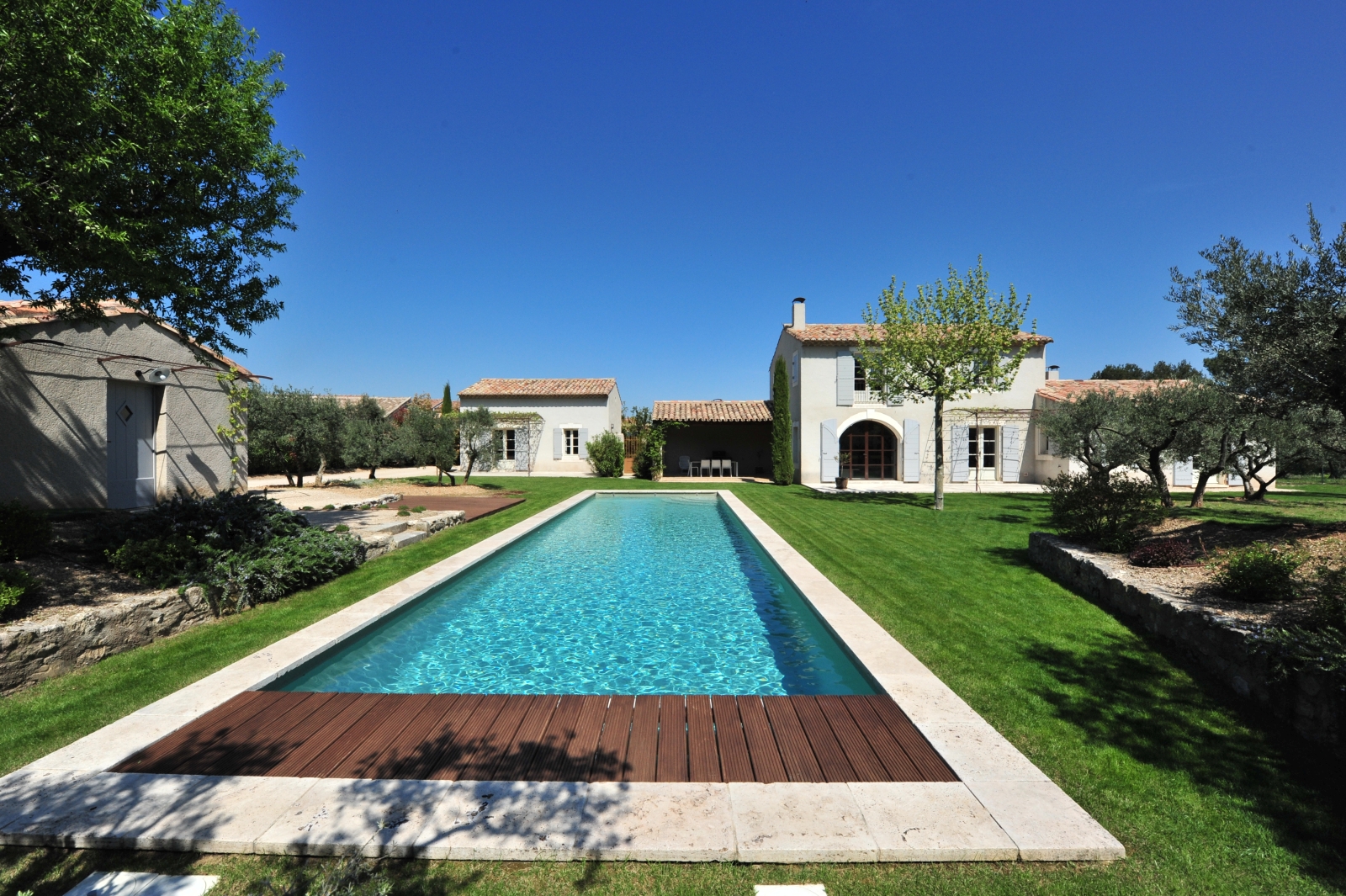 Shot of long pool with villa in the background at Mas Eygalieres in Provence