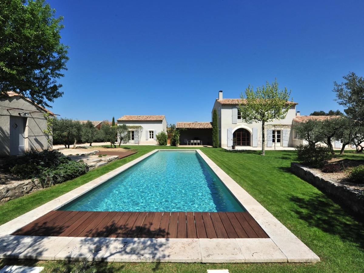Shot of long pool with villa in the background at Mas Eygalieres in Provence