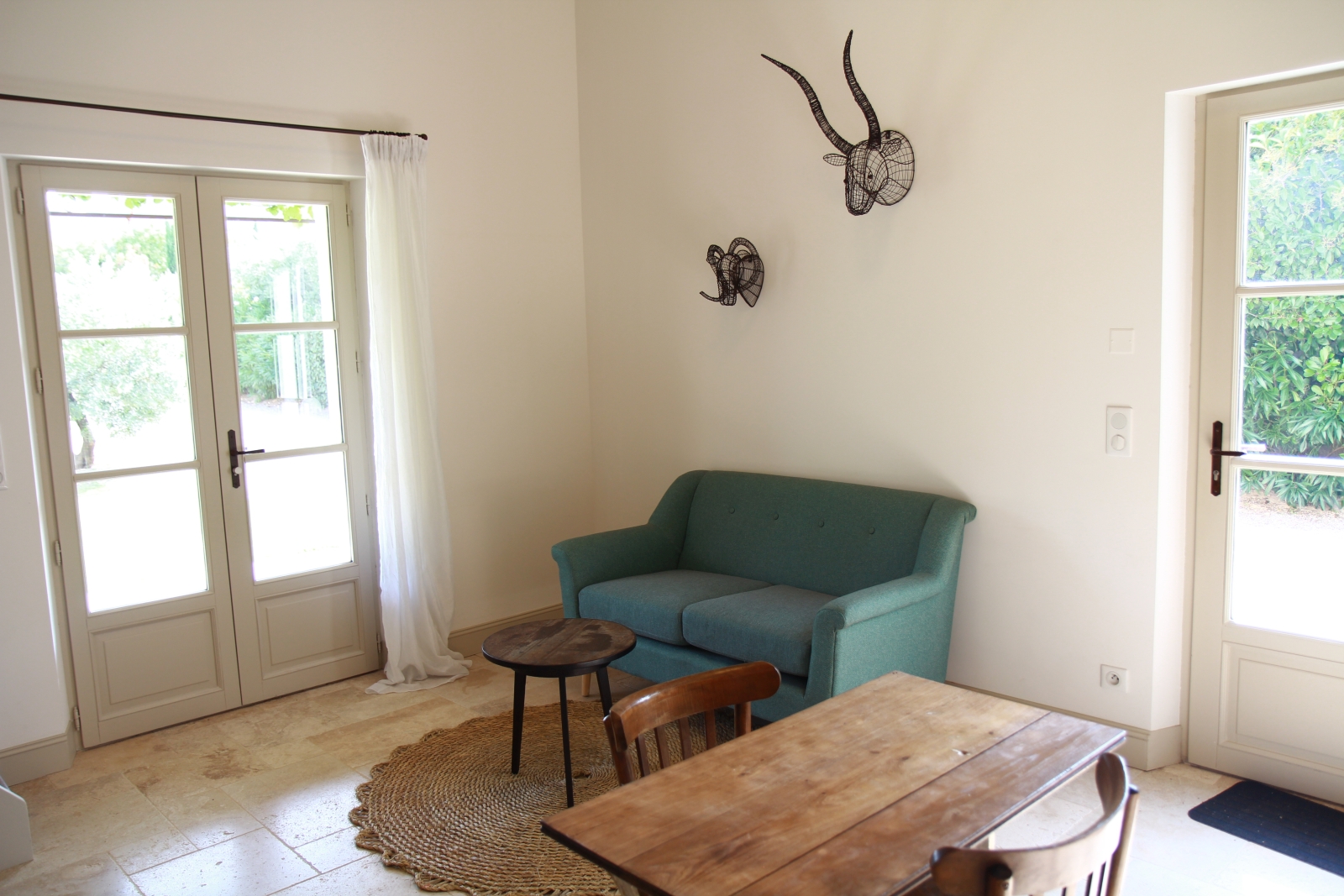 Guest house living area with small table and sofa at Mas Eygalieres in Provence