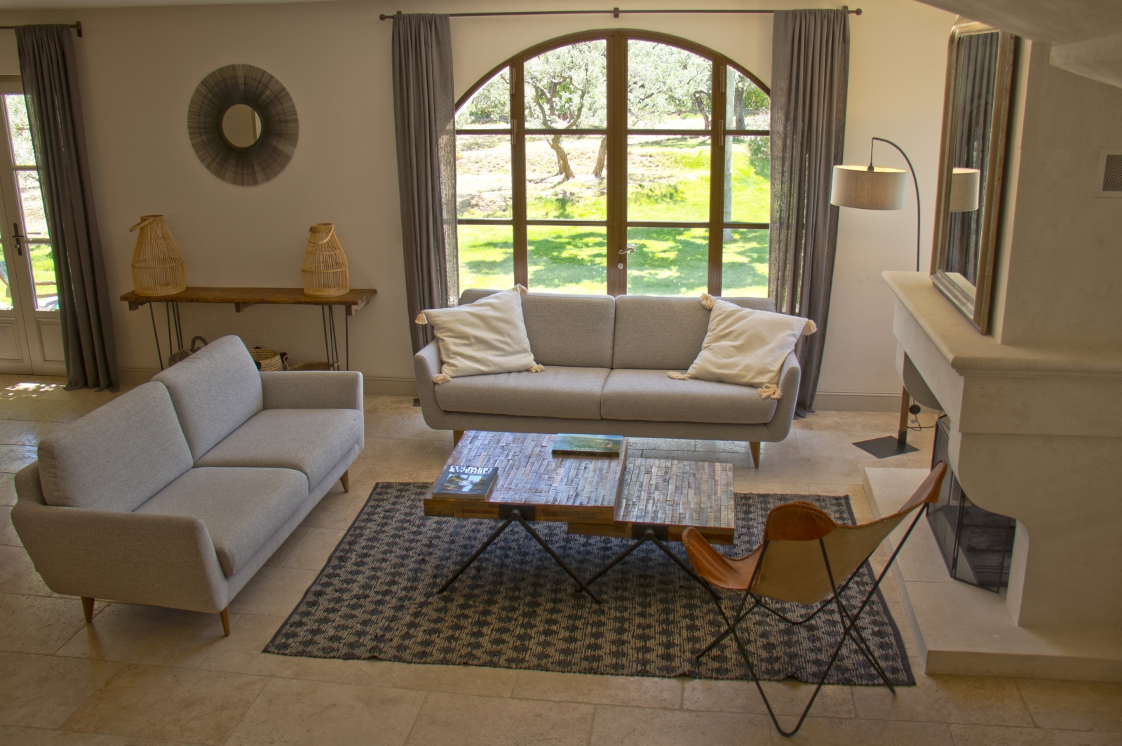 Living room from stairs with white sofas and fireplace at Mas Eygalieres in Provence
