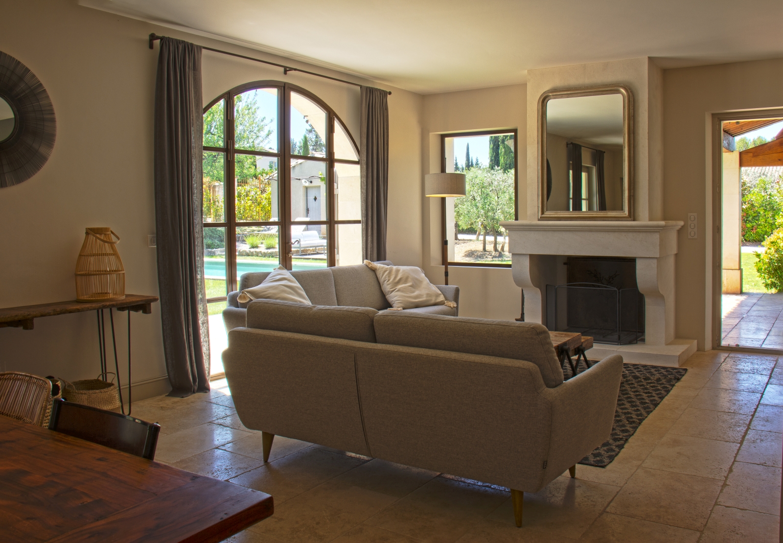 Living room with doors leading to garden at Mas Eygalieres in Provence