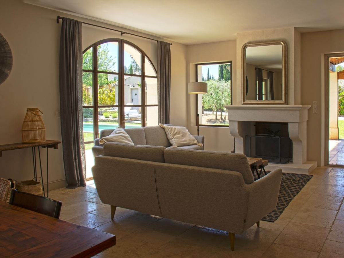 Living room with doors leading to garden at Mas Eygalieres in Provence