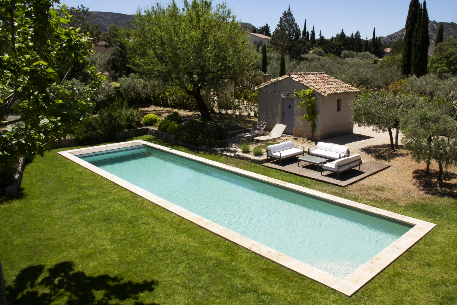 Aerial of pool with pool house and loungers at Mas Eygalieres in Provence