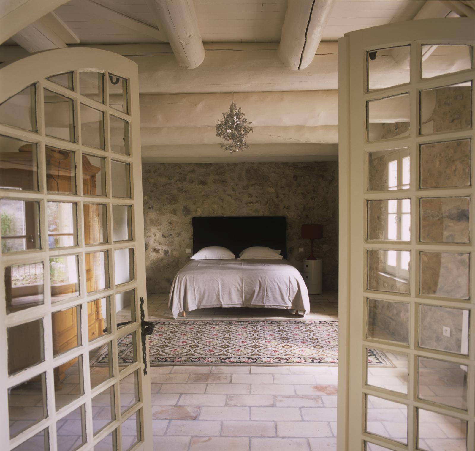 Double bedroom seen through entrance in Mas Jaisses, Provence