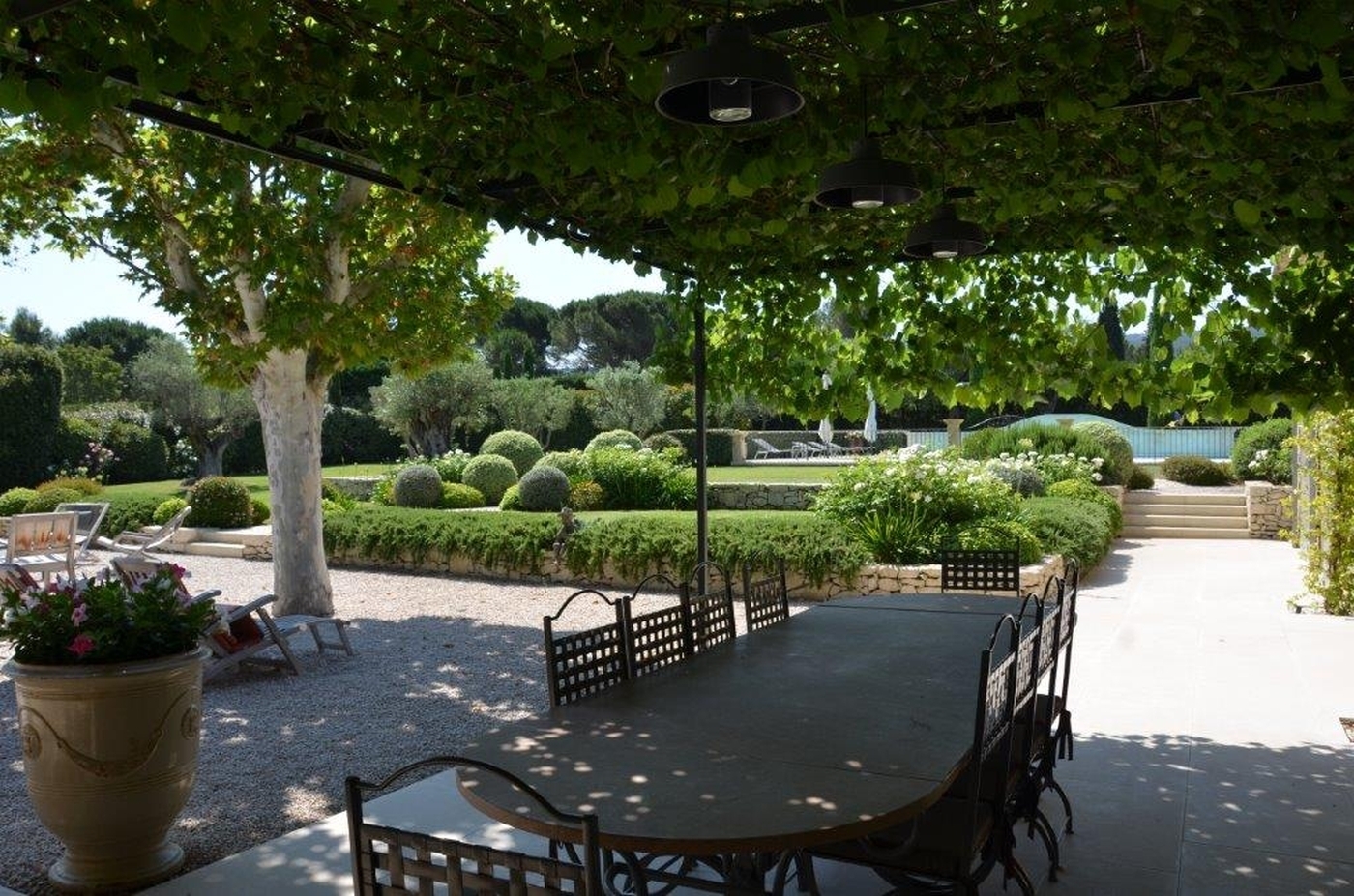 Covered outdoor seating with garden at Mas Laurent in Provence