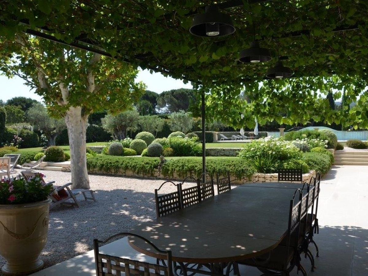 Covered outdoor seating with garden at Mas Laurent in Provence