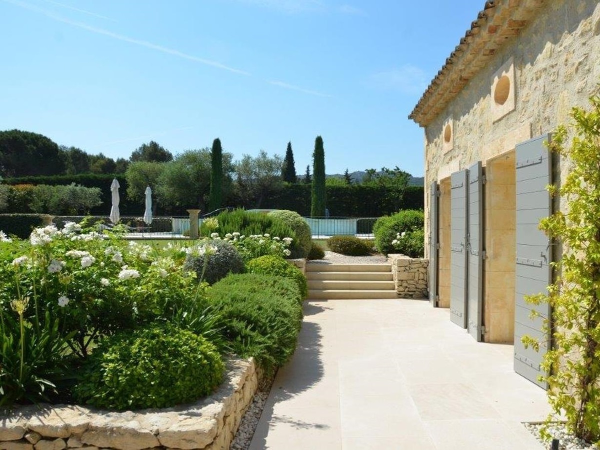 Exterior of property with stone courtyard at Mas Laurent in Provence