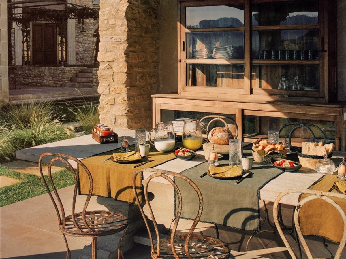 outdoor dining table and chairs on terrace at villa athena in provence, france set for lunch