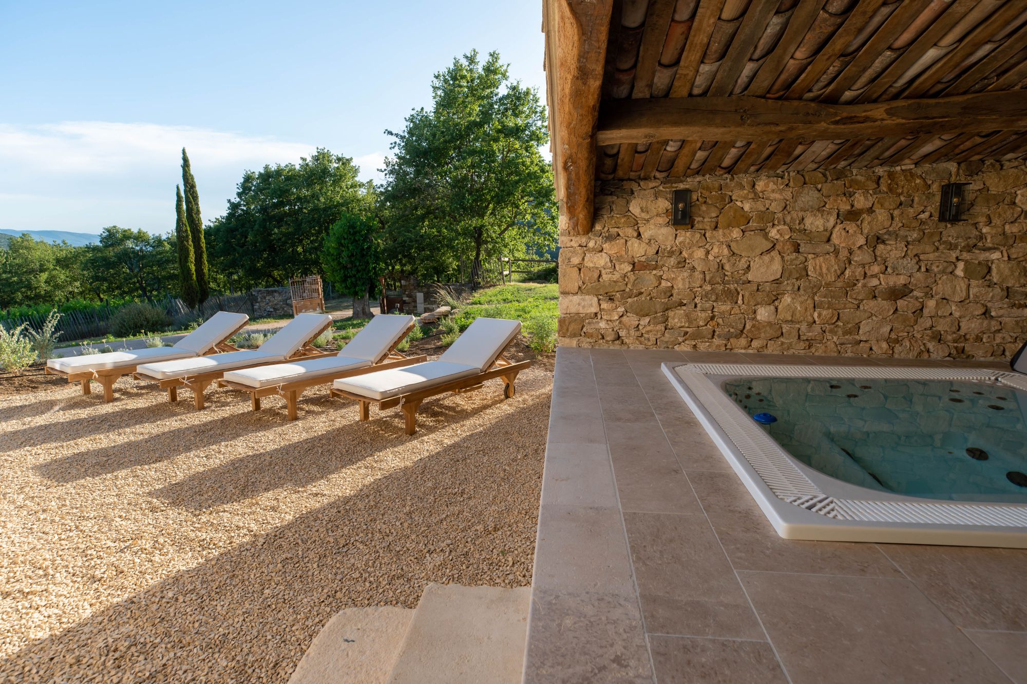 Hot tub and sun loungers at Villa Thyme